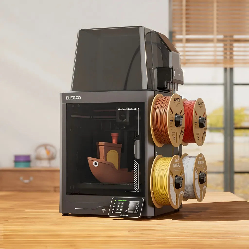 Desktop setup showing Centauri Carbon 2 Combo and four filament spools